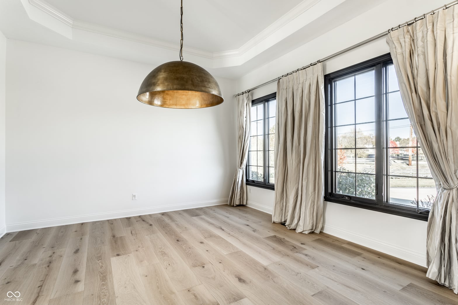 Bright dining room with hardwood floors and abundant natural light.