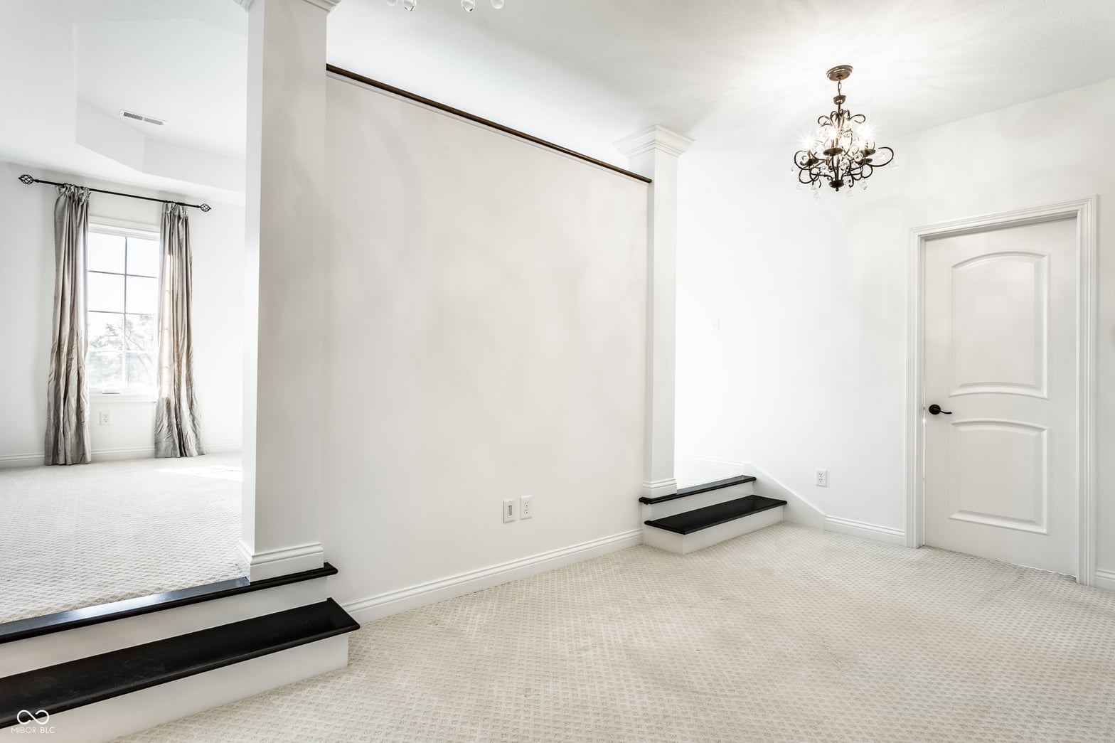 Bright, spacious primary suite with elegant architectural details.