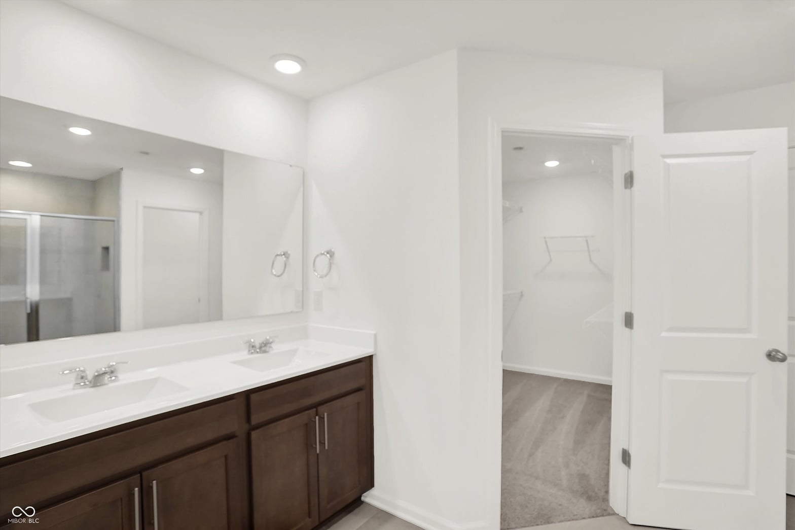 Luxurious primary bath with double vanity and walk-in shower.