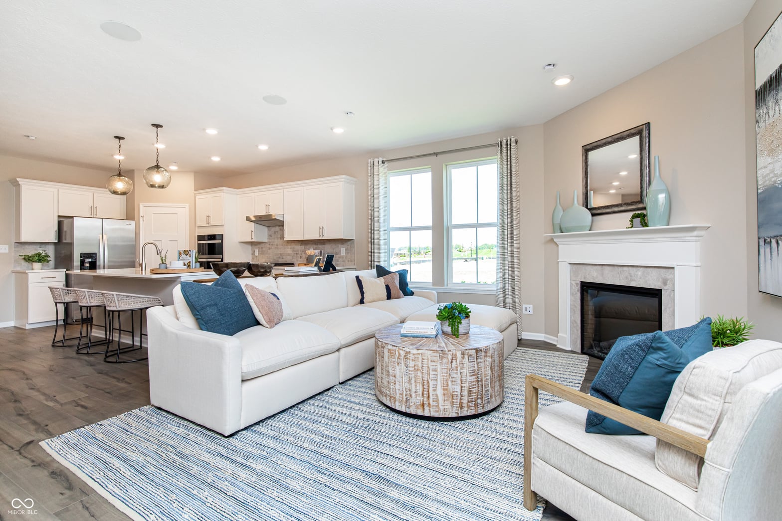 Bright, modern living space with fireplace and kitchen views.
