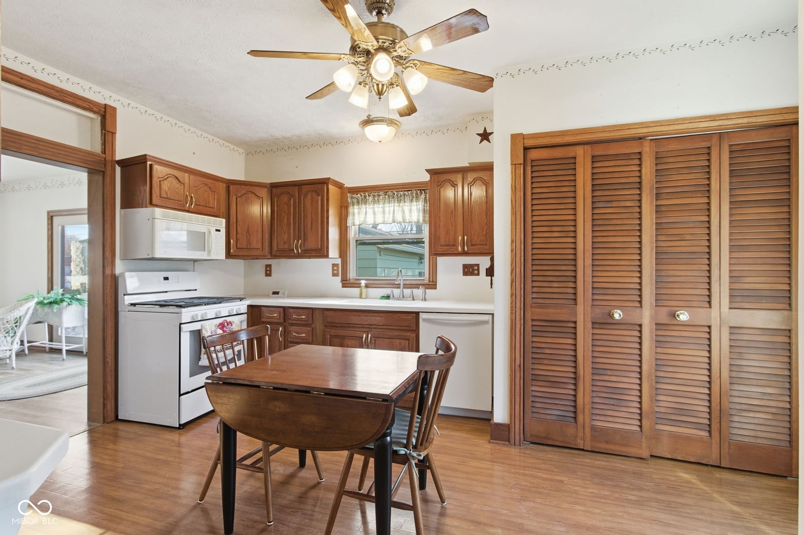 Charming traditional kitchen with wood cabinetry and hardwood floors.