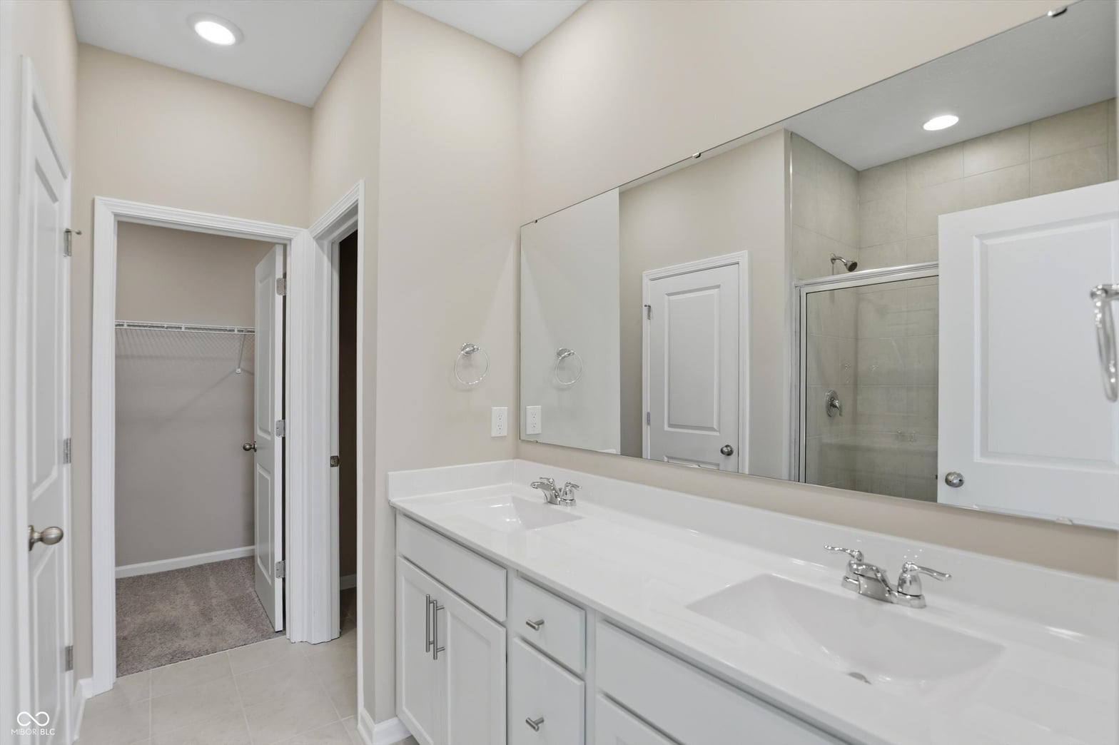 Luxurious primary bath with dual vanity and spa shower.