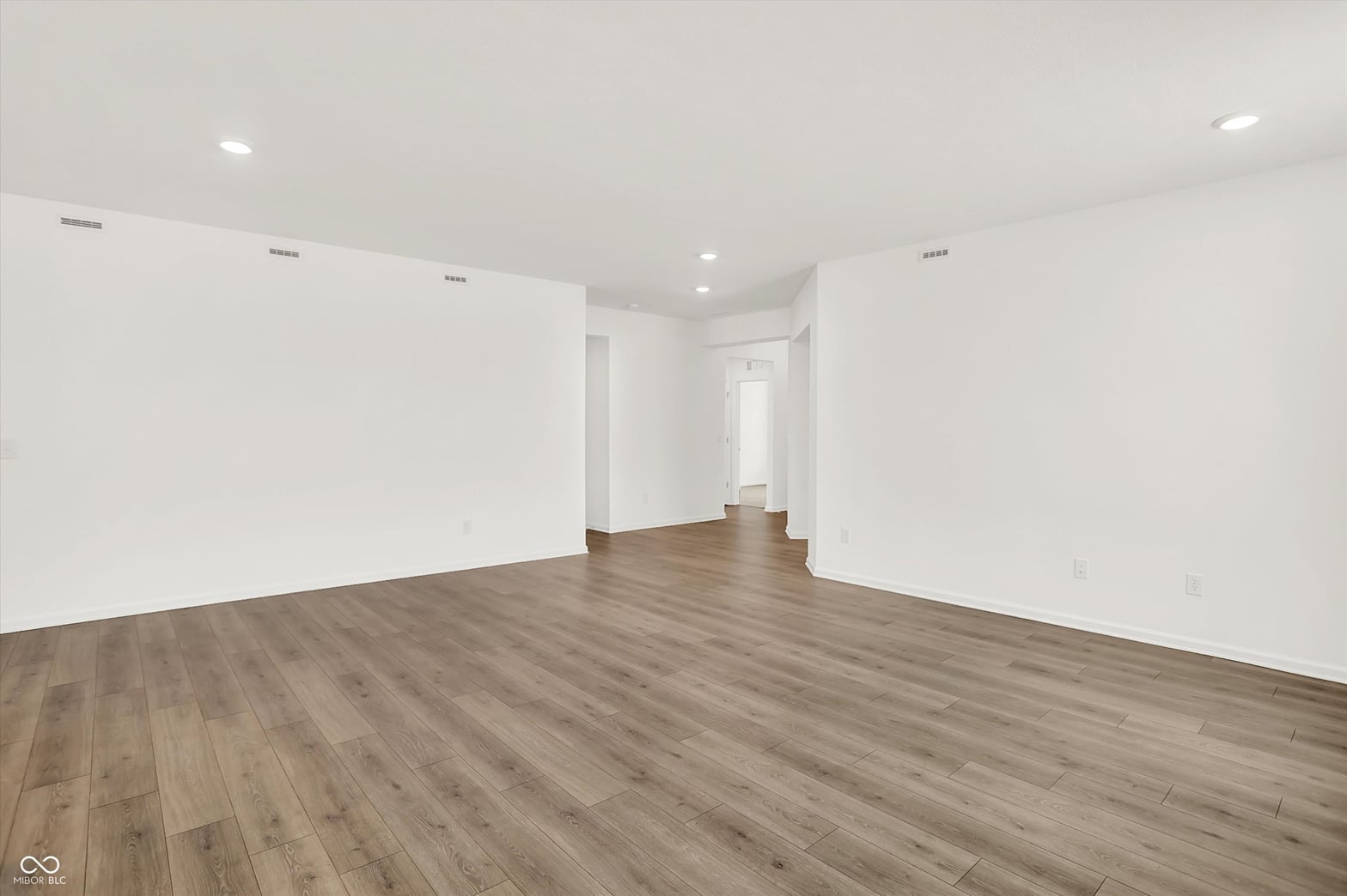 Bright, open living space with modern finishes and wood-look flooring.