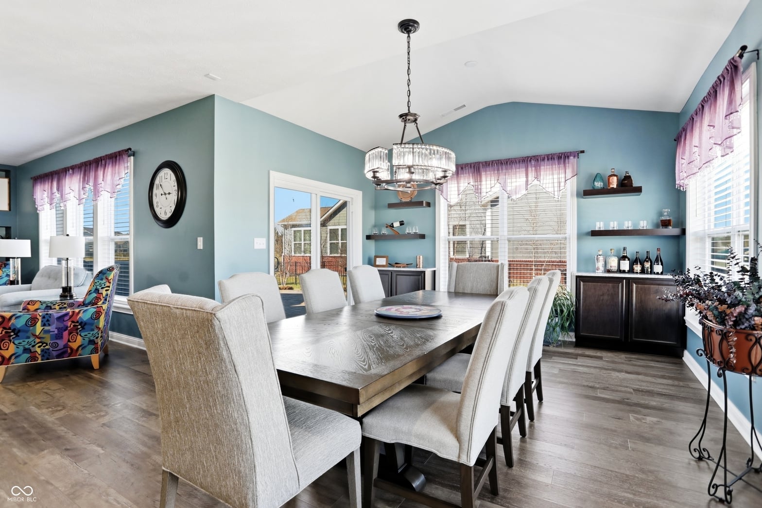 Elegant contemporary dining with crystal chandelier and patio access.