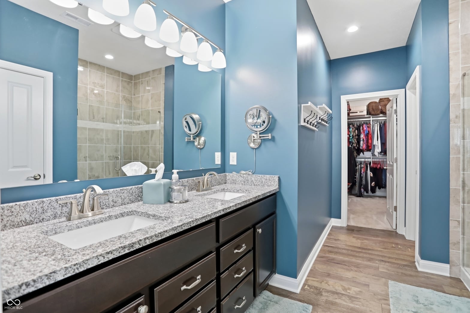Luxurious primary bath with dual vanity and walk-in closet.