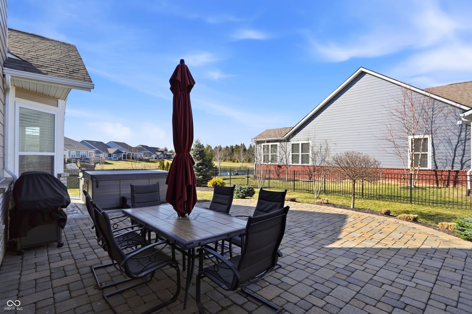 Spacious paver patio with pool and entertaining space.