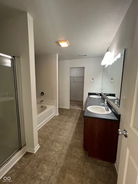 Primary bathroom at 1225 Maple Trace Way, Sheridan, IN — Spacious primary bath with dual vanity and modern finishes.