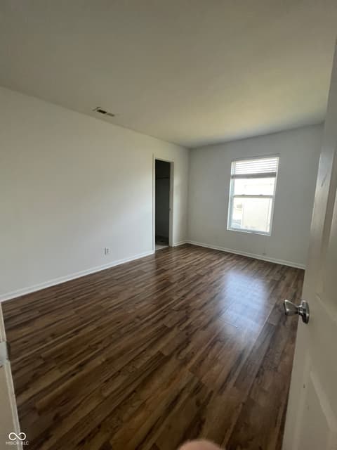 Bedroom at 1225 Maple Trace Way, Sheridan, IN — Spacious bedroom with beautiful hardwood floors.