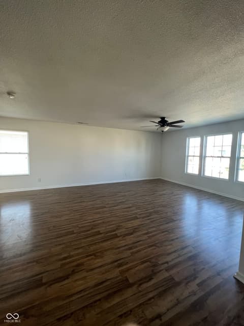 Living room at 1225 Maple Trace Way, Sheridan, IN — Bright open living space with beautiful hardwood floors.