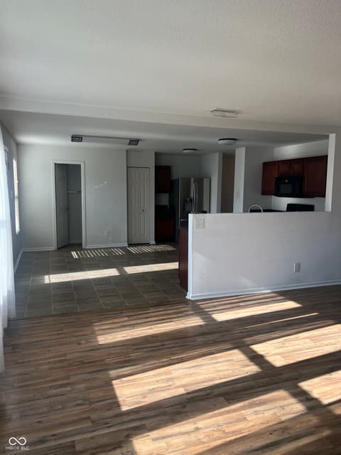 Family room at 1225 Maple Trace Way, Sheridan, IN — Bright open layout with mixed flooring and modern kitchen.