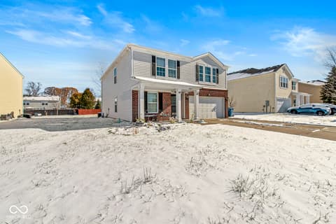Front exterior at 1225 Maple Trace Way, Sheridan, IN — Brick colonial with attached garage and covered porch.