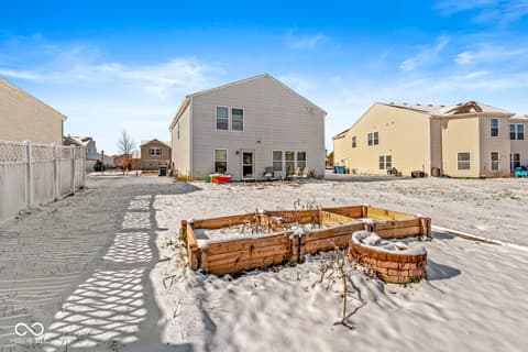 Backyard at 1225 Maple Trace Way, Sheridan, IN — Beachfront property with fire pit and raised garden beds.