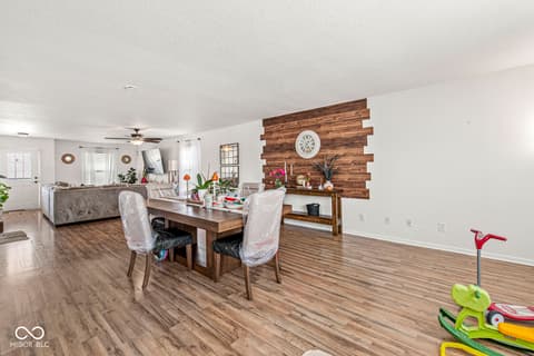 Dining room at 1225 Maple Trace Way, Sheridan, IN — Spacious dining area with striking wood accent wall.