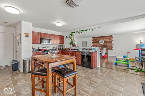 Kitchen at 1225 Maple Trace Way, Sheridan, IN — Spacious kitchen with island and modern wood accents.