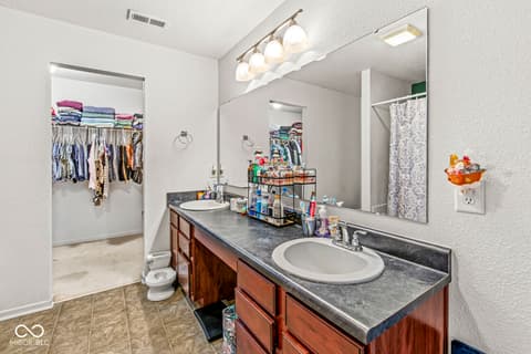 Primary bathroom at 1225 Maple Trace Way, Sheridan, IN — Spacious primary bath with double vanity and walk-in closet.