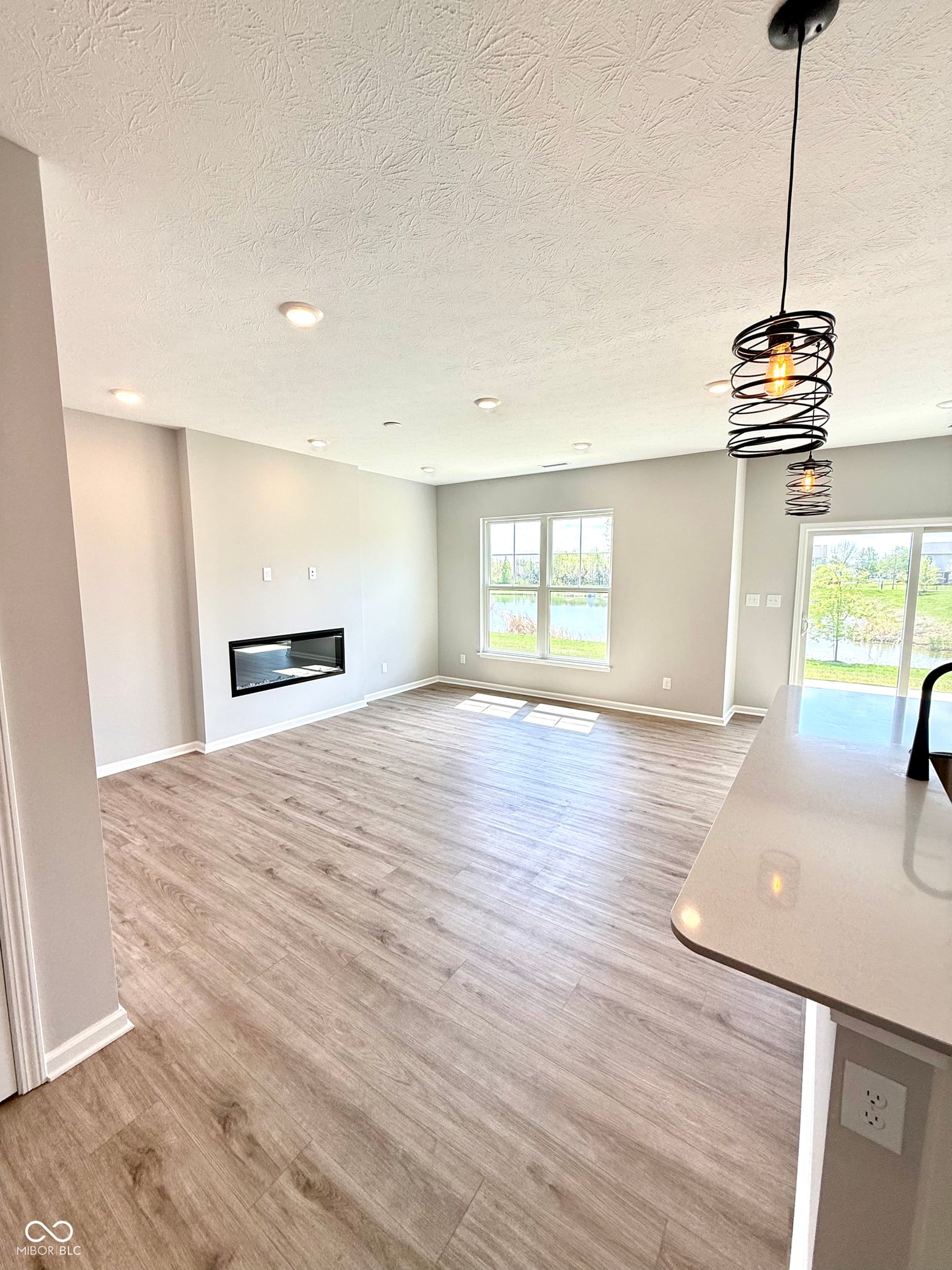 Bright modern living space with fireplace and abundant natural light.
