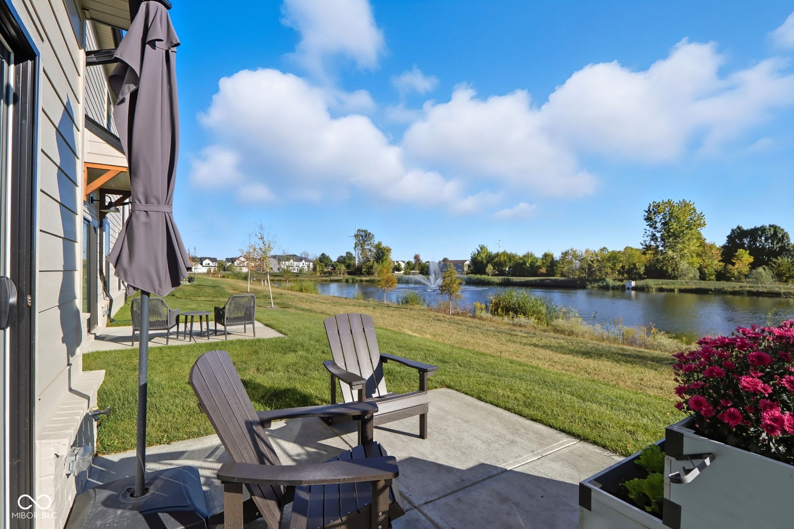 Stunning waterfront patio with river views and landscaping.
