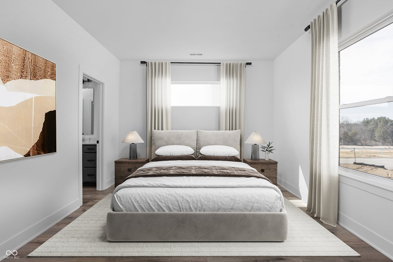 Bright primary suite with expansive windows and ensuite access.