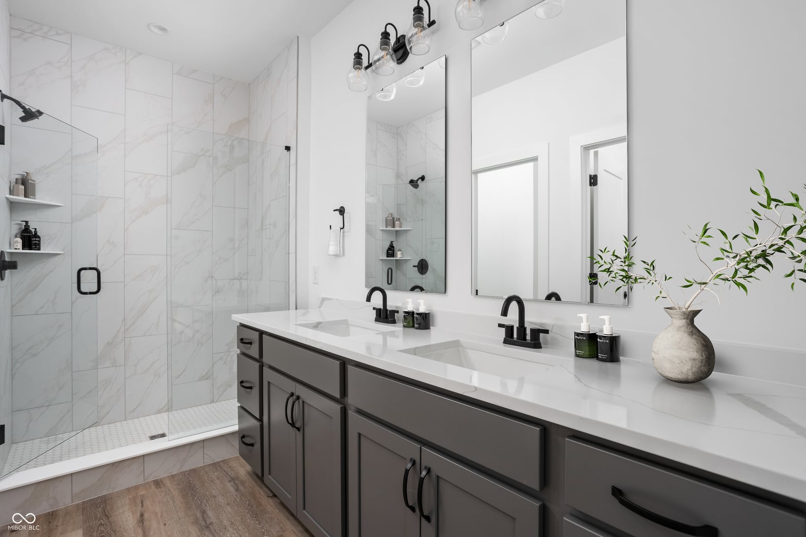 Luxurious primary bath with marble and double vanity.