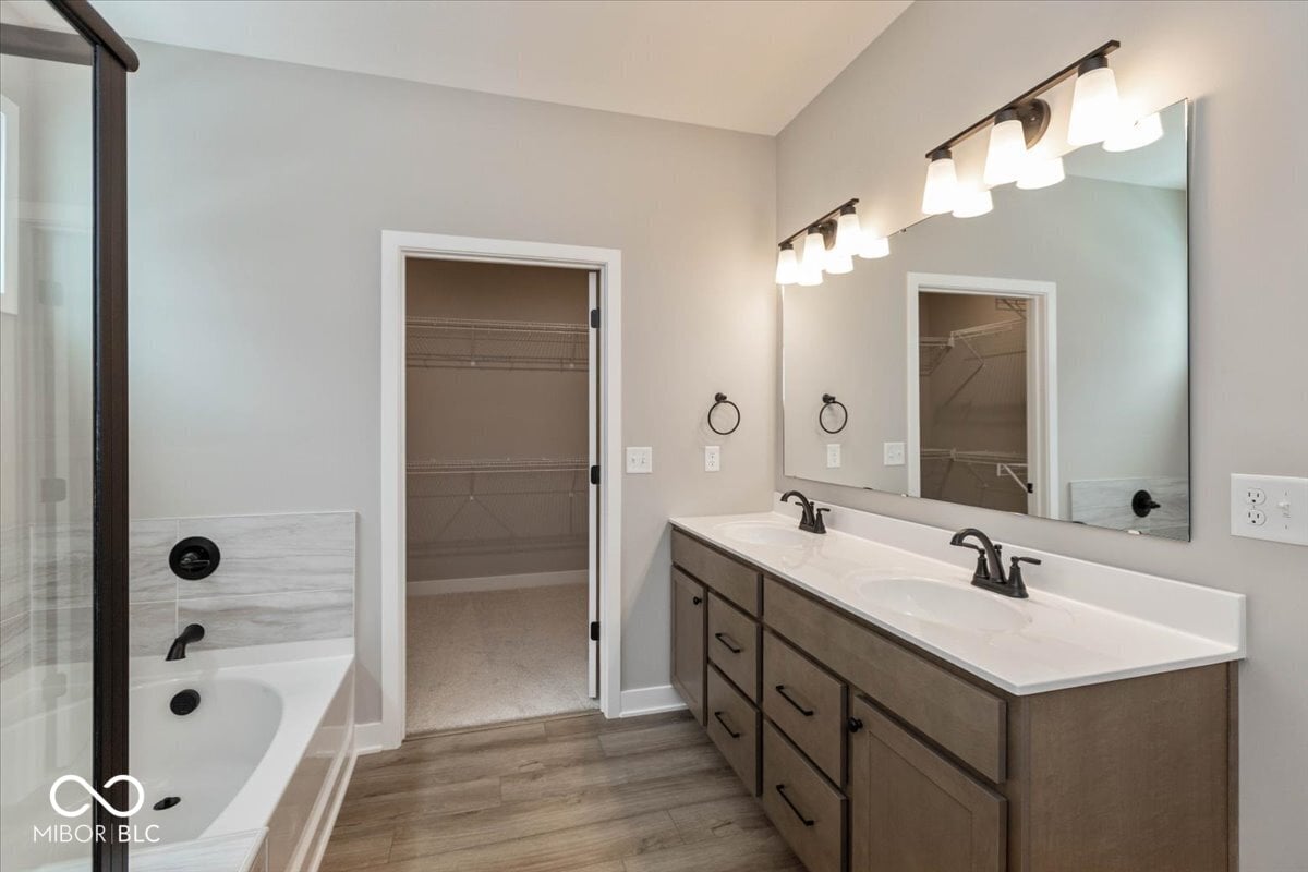 Luxurious primary bath with double vanity and walk-in shower.