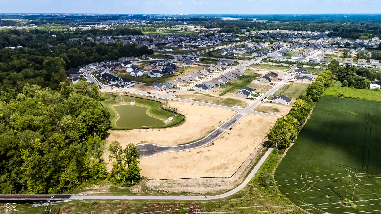 New suburban development with golf course and mature trees.