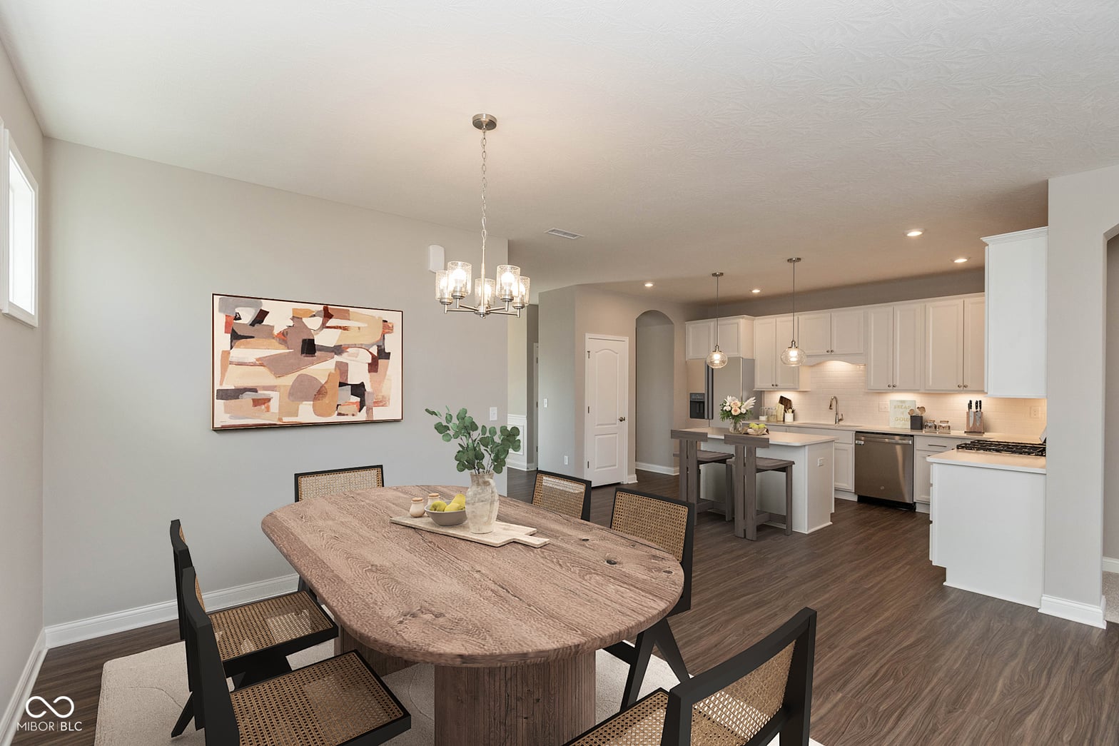 Modern open-concept dining and kitchen with white cabinetry.