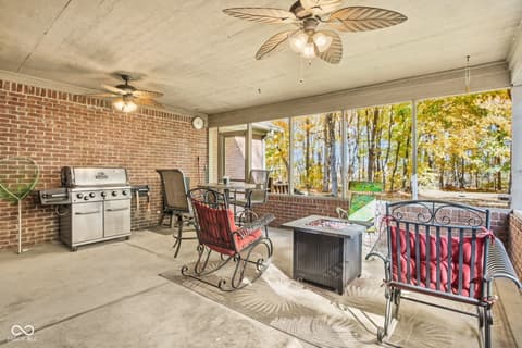 Outdoor living area at 10791 E State Road 47, Sheridan, IN — Spacious screened porch with fire pit and grill.