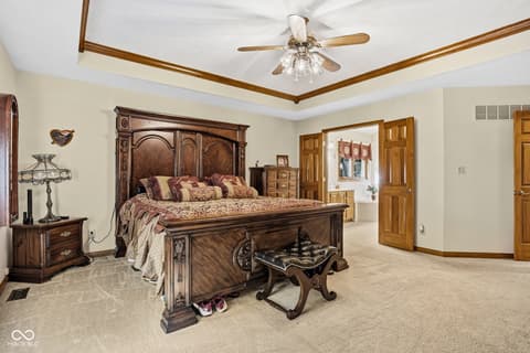 Primary bedroom at 10791 E State Road 47, Sheridan, IN — Spacious primary bedroom with ornate wood ceiling beams.