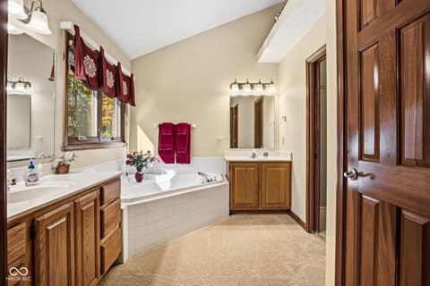 Primary bathroom at 10791 E State Road 47, Sheridan, IN — Spacious primary bath with dual vanities and soaking tub.
