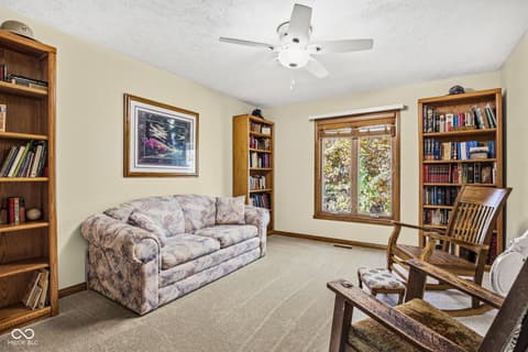 Family room at 10791 E State Road 47, Sheridan, IN — Cozy family room with abundant built-in bookshelves.