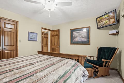 Primary bedroom at 10791 E State Road 47, Sheridan, IN — Spacious primary bedroom with original wood doors and trim.
