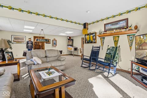 Bonus room at 10791 E State Road 47, Sheridan, IN — Large finished basement with sports-themed recreation room.