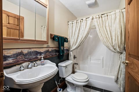 Bathroom at 10791 E State Road 47, Sheridan, IN — Updated bathroom with pedestal sink and scenic backsplash.