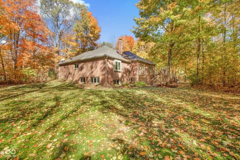 Backyard at 10791 E State Road 47, Sheridan, IN — Charming brick home on mature wooded lot with deck.