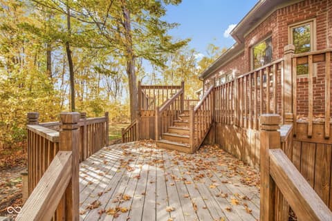 Backyard at 10791 E State Road 47, Sheridan, IN — Multi-level wooden deck with wooded backdrop.