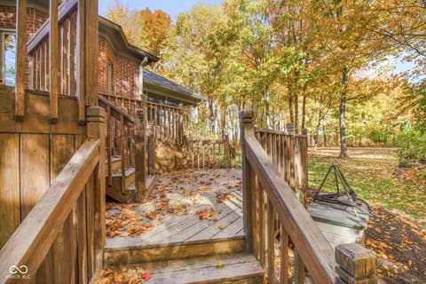 Backyard at 10791 E State Road 47, Sheridan, IN — Waterfront property with wooded setting and mature trees.