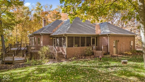 Backyard at 10791 E State Road 47, Sheridan, IN — Spacious brick home with screened porch and multiple decks.