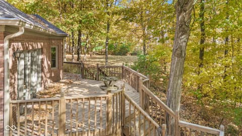 Backyard at 10791 E State Road 47, Sheridan, IN — Expansive wooded deck with mature trees and privacy.