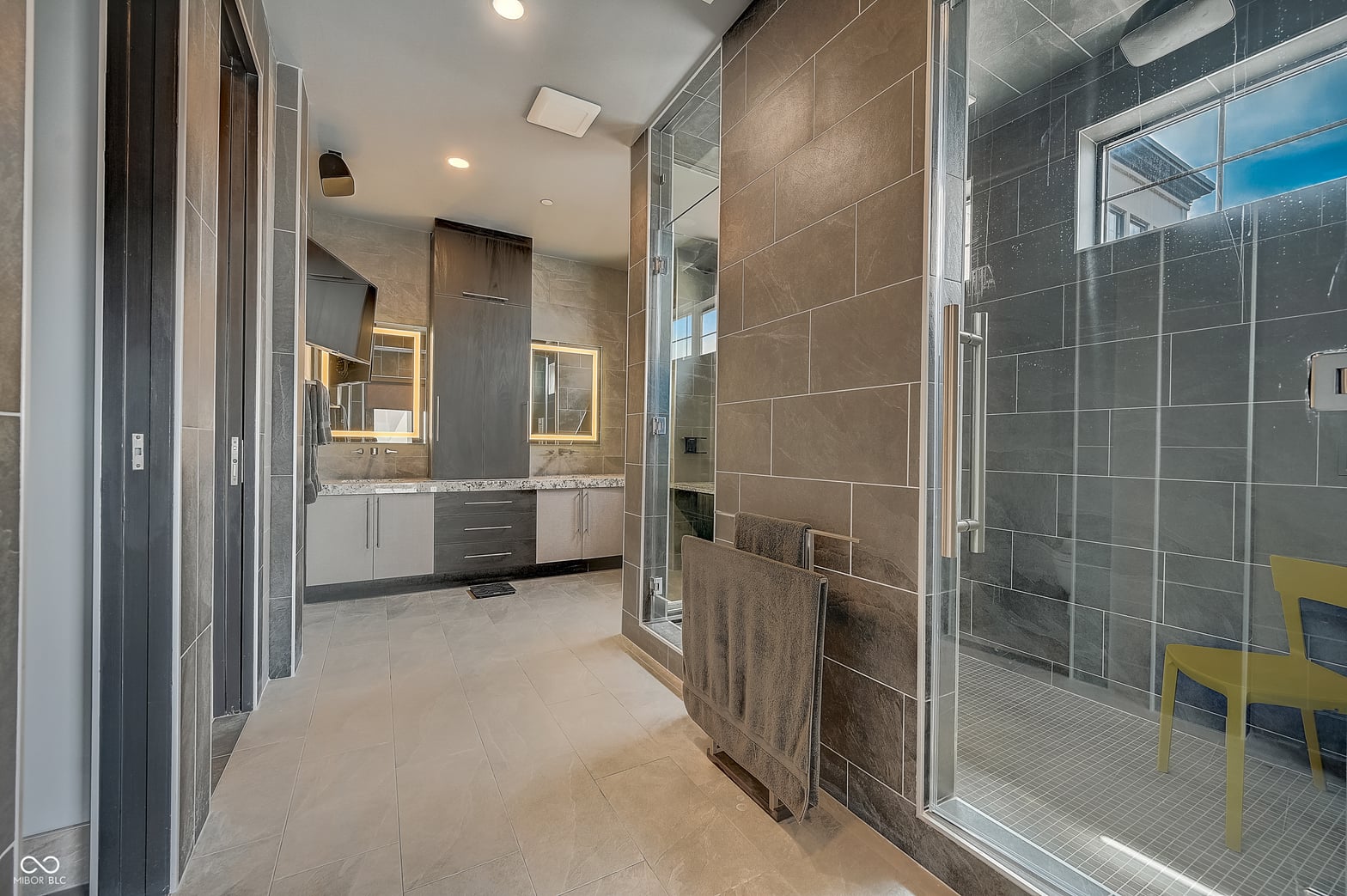 Luxurious primary bath with dual vanity and spa shower.