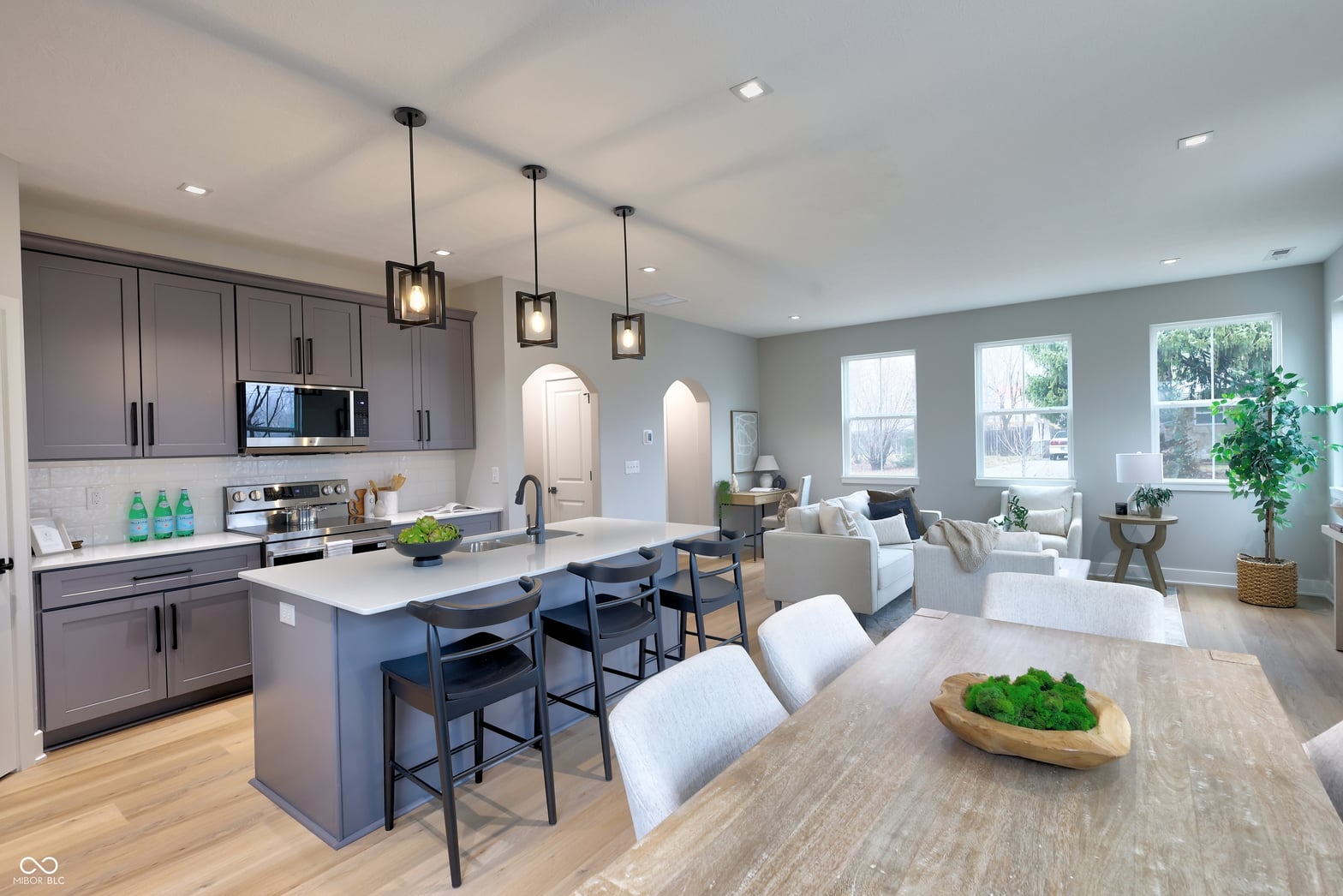 Modern kitchen with expansive island and open living space.