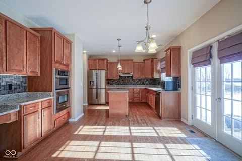 Kitchen at 14903 Stable Stone Terrace, Fishers, IN — Spacious, bright kitchen with cherry cabinets and granite.