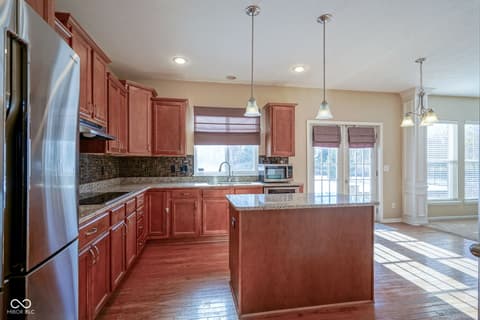 Kitchen at 14903 Stable Stone Terrace, Fishers, IN — Spacious updated kitchen with granite and cherry cabinetry.