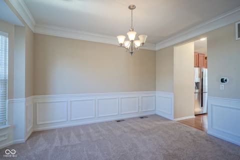 Dining room at 14903 Stable Stone Terrace, Fishers, IN — Elegant dining room with architectural wainscoting details.
