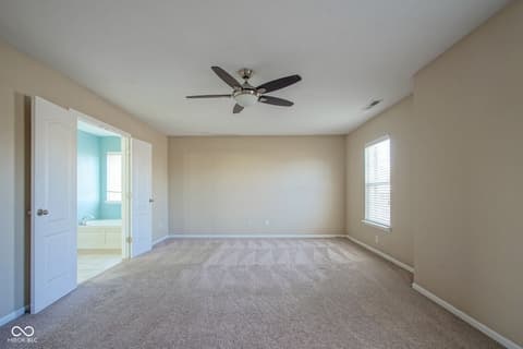 Primary bedroom at 14903 Stable Stone Terrace, Fishers, IN — Spacious primary bedroom with ensuite bathroom access.