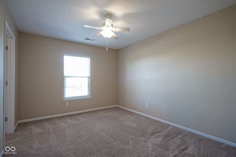 Bedroom at 14903 Stable Stone Terrace, Fishers, IN — Bright secondary bedroom with ceiling fan and natural light.