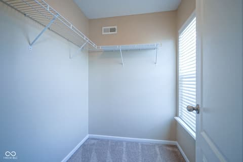 Laundry room at 14903 Stable Stone Terrace, Fishers, IN — Bright laundry room with shelving and natural light.