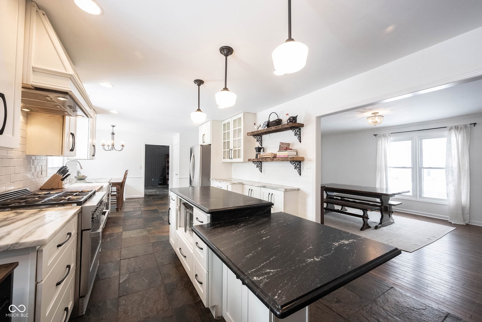 Spacious updated kitchen with marble island and modern finishes.