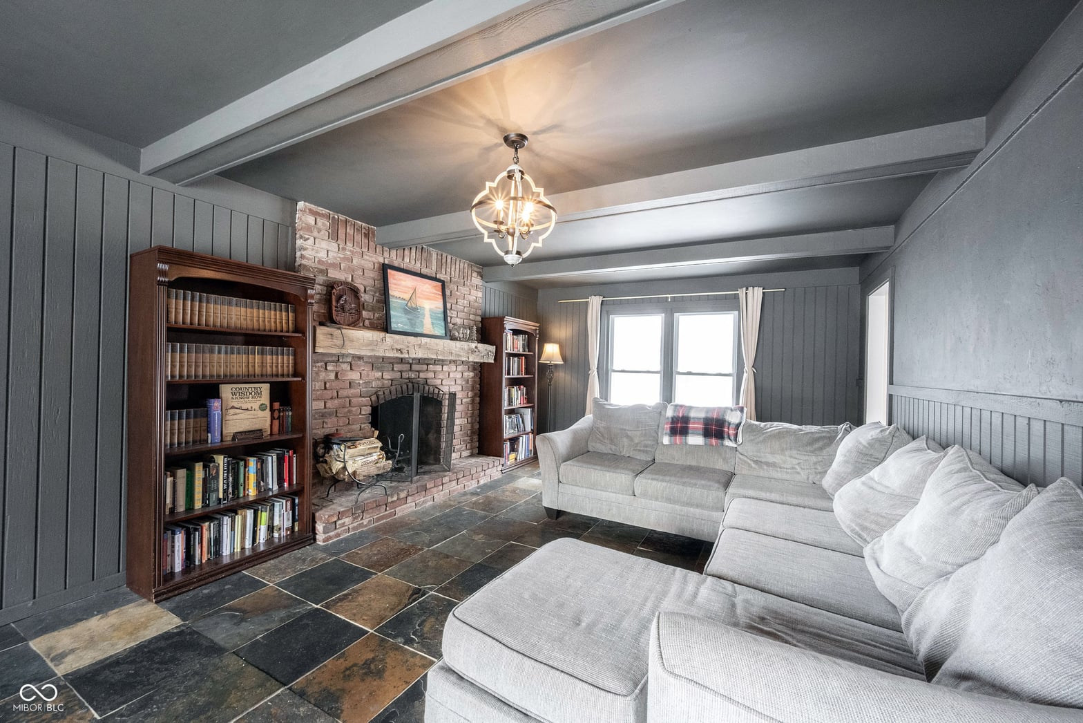 Elegant family room with fireplace and built-in shelving.