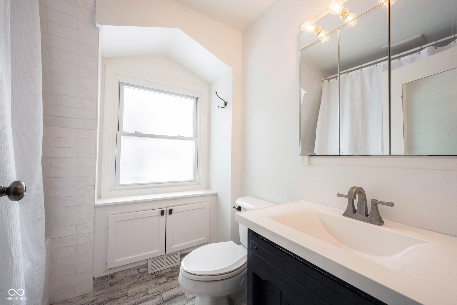 Modern primary bath with updated finishes and natural light.