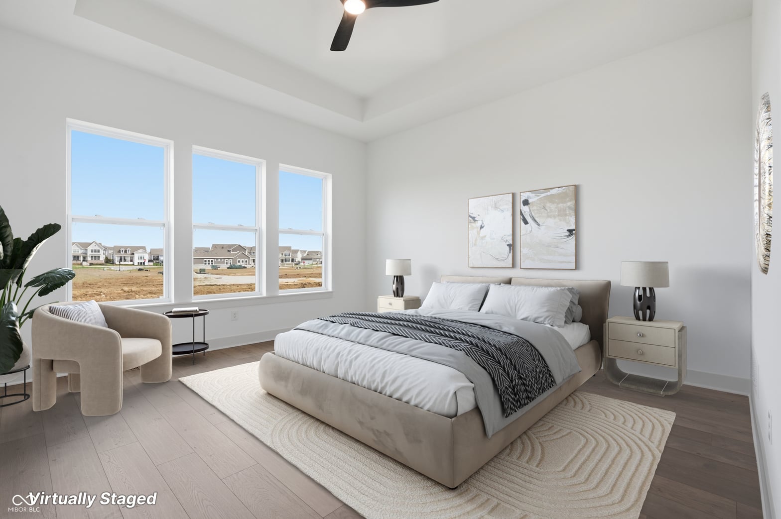 Bright primary bedroom with expansive windows and neighborhood views.